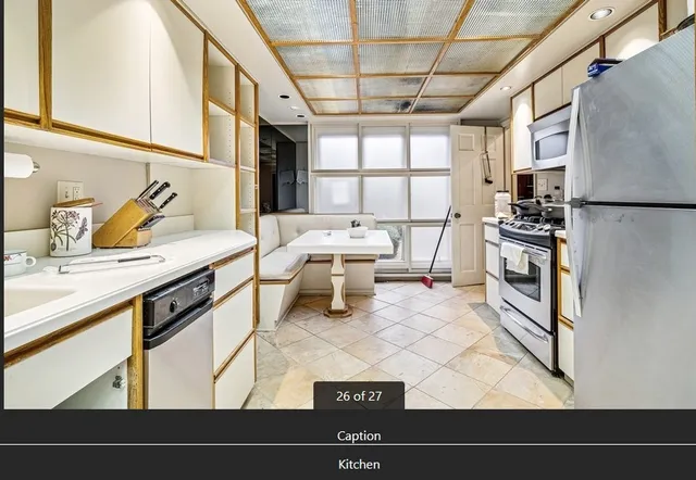 a kitchen with a sink appliances and cabinets