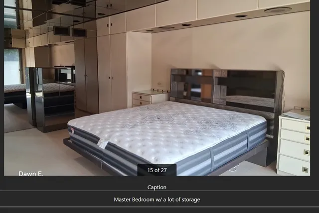 a room with a bed and a television