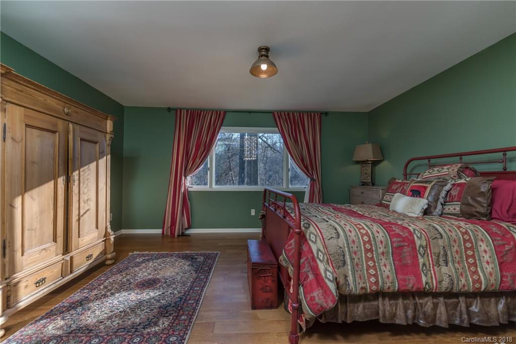 29 Hunting Country Trail Tryon, NC 28782 - Photo 13 of 20 a bed sitting in a bedroom next to a window