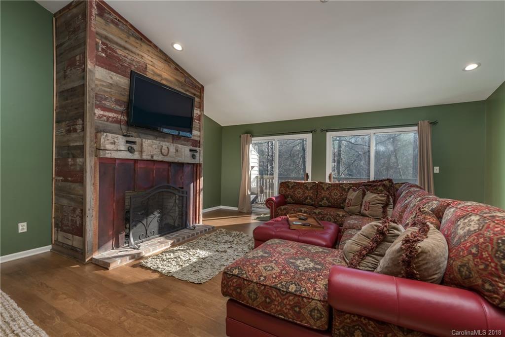 29 Hunting Country Trail Tryon, NC 28782 - Photo 6 of 20 a living room with furniture a flat screen tv and a fireplace