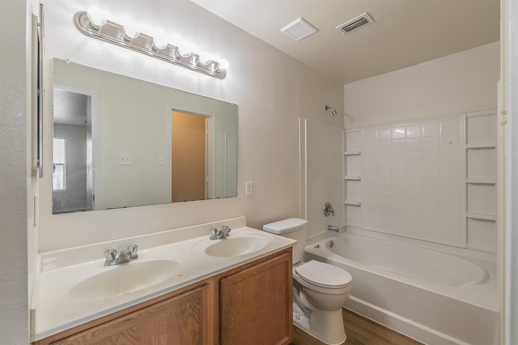 213 Cres Ridge Drive Fort Worth, TX 76140 - Photo 17 of 32 a bathroom with a sink a toilet and shower