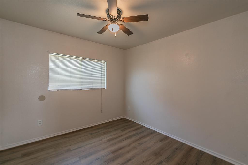 213 Cres Ridge Drive Fort Worth, TX 76140 - Photo 18 of 32 an empty room with a window and a fan