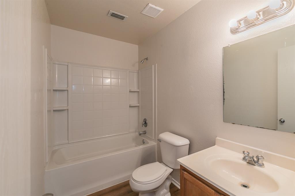 213 Cres Ridge Drive Fort Worth, TX 76140 - Photo 22 of 32 a bathroom with a sink toilet and shower