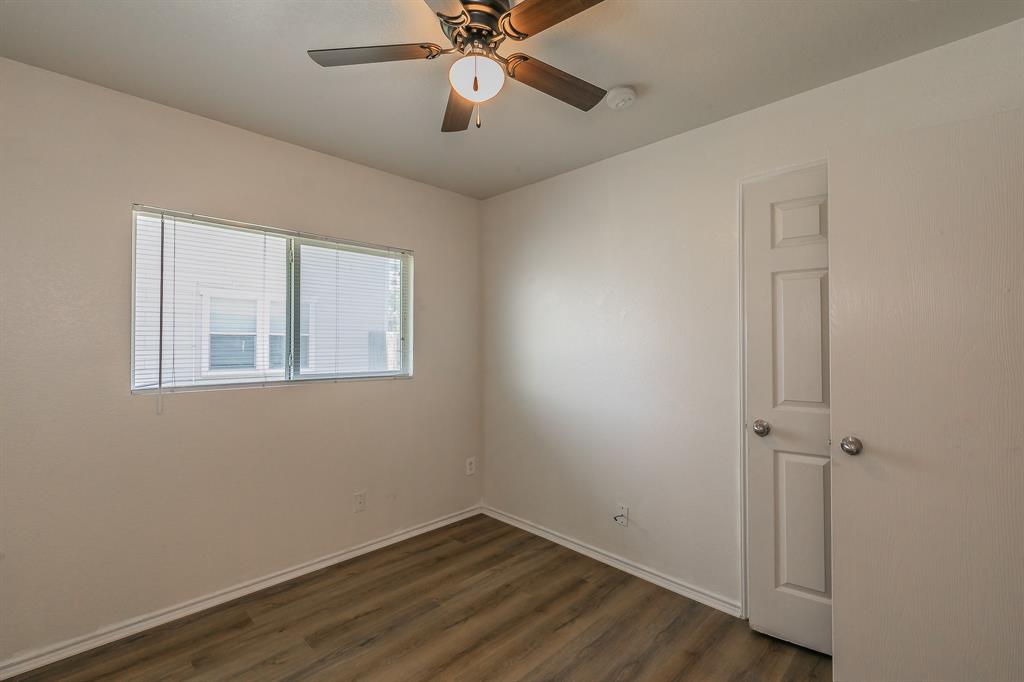 213 Cres Ridge Drive Fort Worth, TX 76140 - Photo 24 of 32 wooden floor in an empty room with a window
