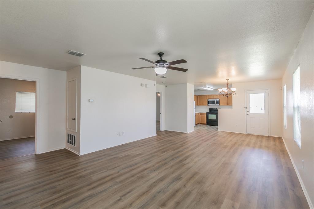 213 Cres Ridge Drive Fort Worth, TX 76140 - Photo 4 of 32 wooden floor in an empty room with a window