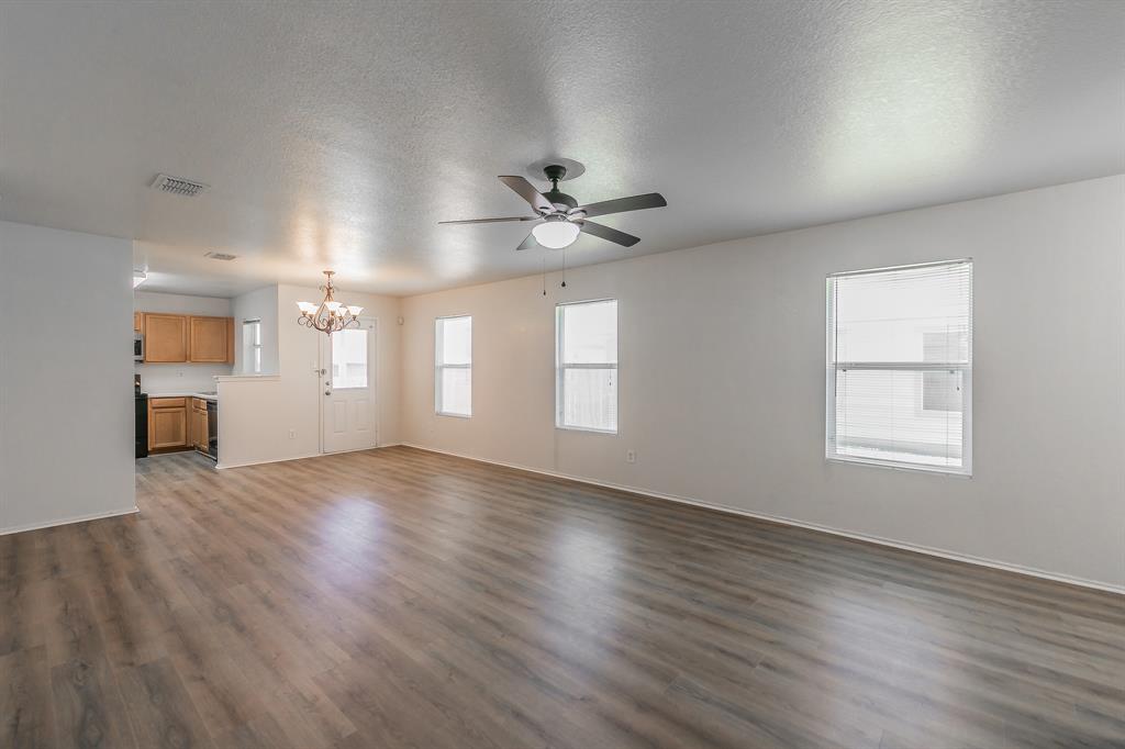 213 Cres Ridge Drive Fort Worth, TX 76140 - Photo 5 of 32 a view of an empty room with wooden floor and a window