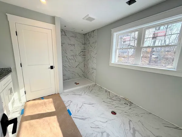a bathroom with a tub sink and shower