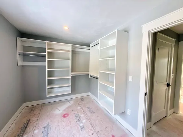 a view of an empty room with a closet