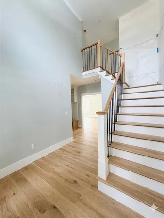 a view of entryway and hall with wooden floor