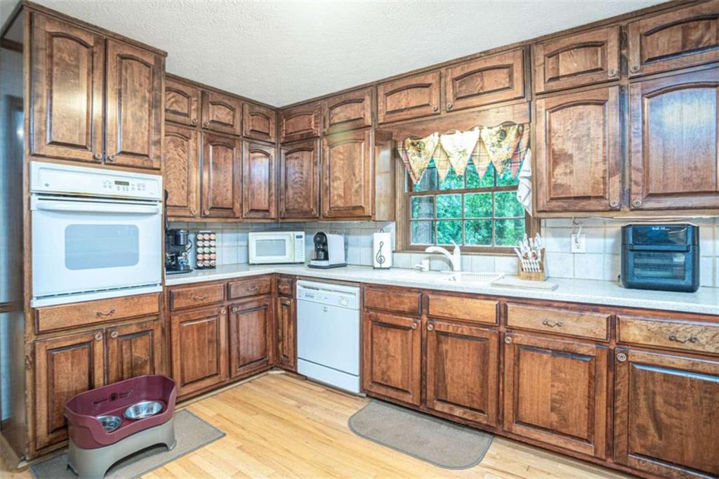 3838 Hunting Ridge Drive Southwest Lilburn, GA 30047 - Photo 22 of 56 a kitchen with stainless steel appliances granite countertop a stove a sink and a microwave