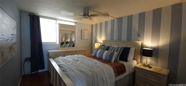 a bedroom with a bed and a mirror