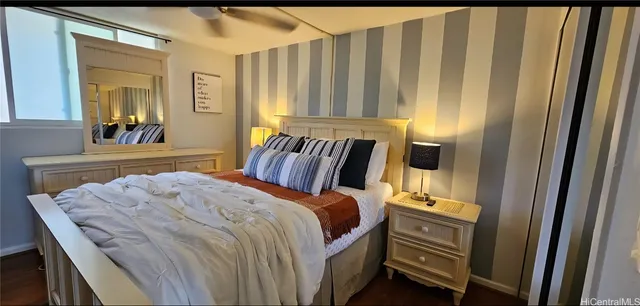 a bedroom with a bed and a mirror