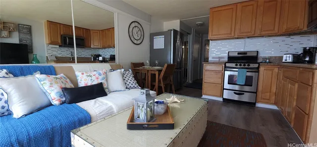 a living room with furniture and kitchen view