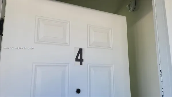 a bathroom with a glass shower door and mirror