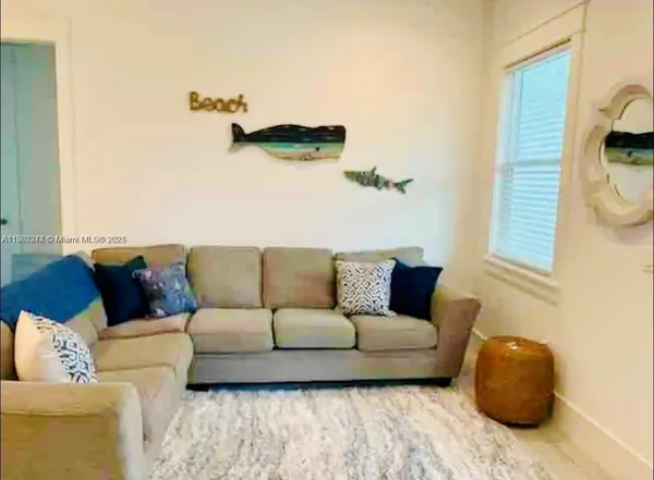 a living room with furniture and a window