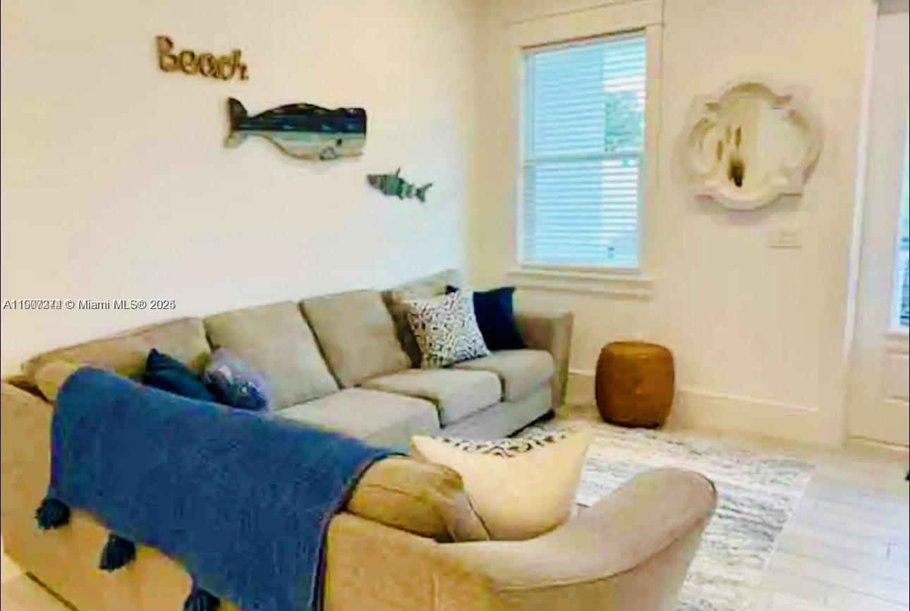 667 Southwest Cleveland Avenue, Unit 3 Stuart, FL 34994 - Photo 14 of 42 a living room with furniture and a couch