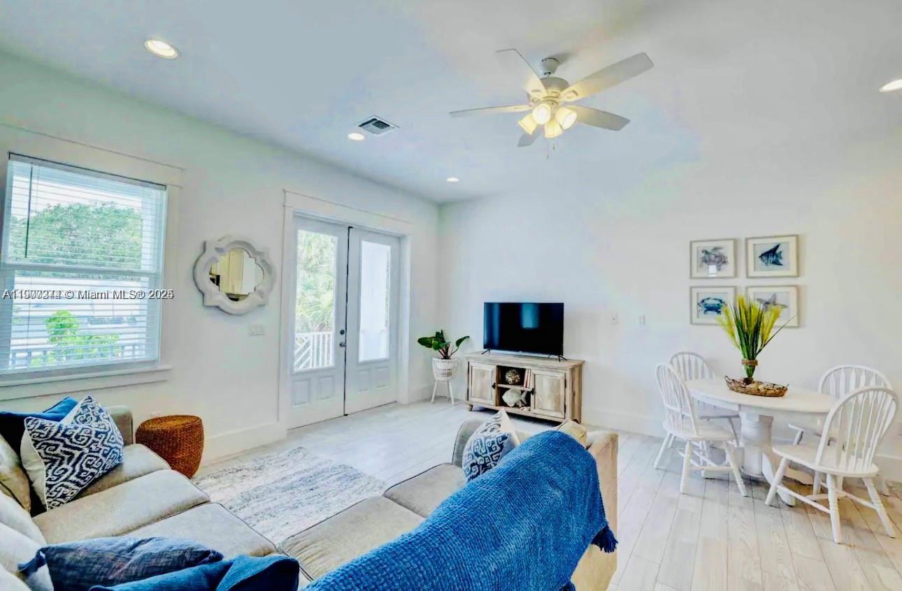 667 Southwest Cleveland Avenue, Unit 3 Stuart, FL 34994 - Photo 15 of 42 a living room with furniture and a flat screen tv