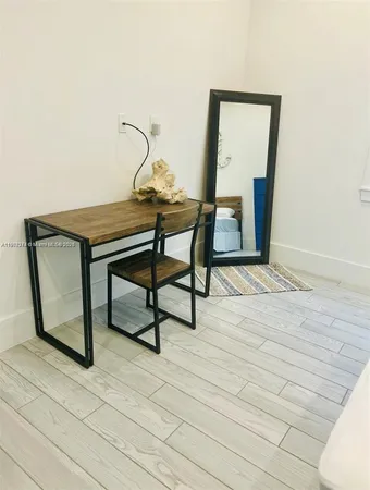 a view of a livingroom with furniture and wooden floor