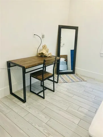 a view of a livingroom with furniture and wooden floor