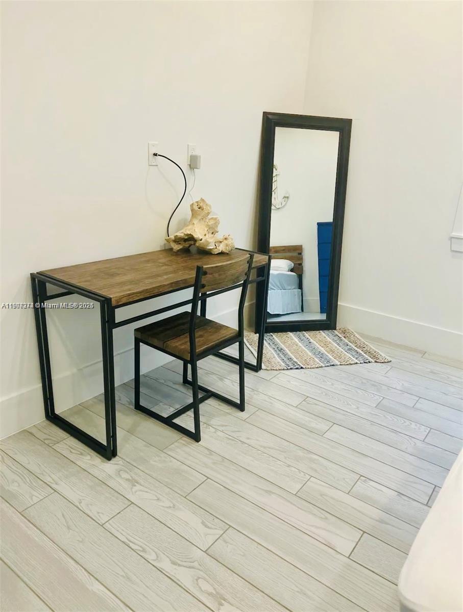 667 Southwest Cleveland Avenue, Unit 3 Stuart, FL 34994 - Photo 18 of 42 a view of a livingroom with furniture and wooden floor
