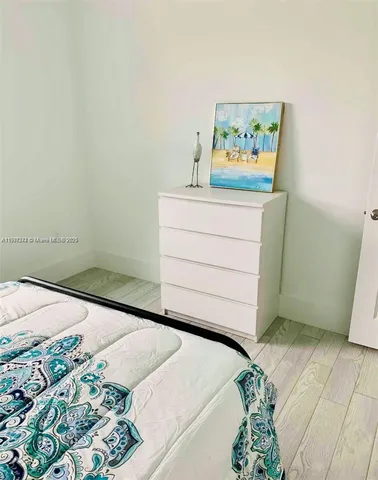 a room with a bed and a painting on the wall