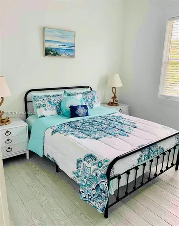 a bedroom with a bed table and window