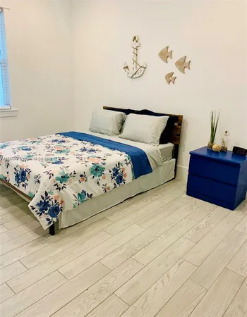 a bedroom with a bed and a dresser