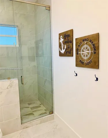 a bathroom with a shower and a sink