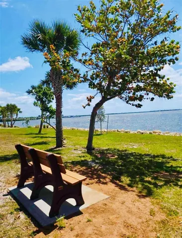 a view of a swimming pool with a patio and a yard