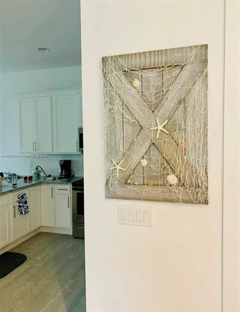 a view of a kitchen with a sink and cabinets