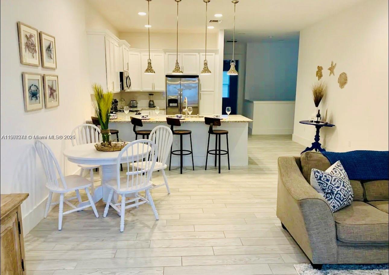 667 Southwest Cleveland Avenue, Unit 3 Stuart, FL 34994 - Photo 6 of 42 a view of a dining room with furniture