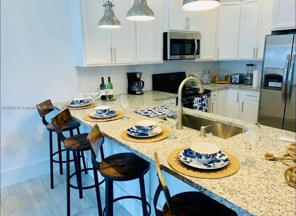 a kitchen with a dining table and chairs