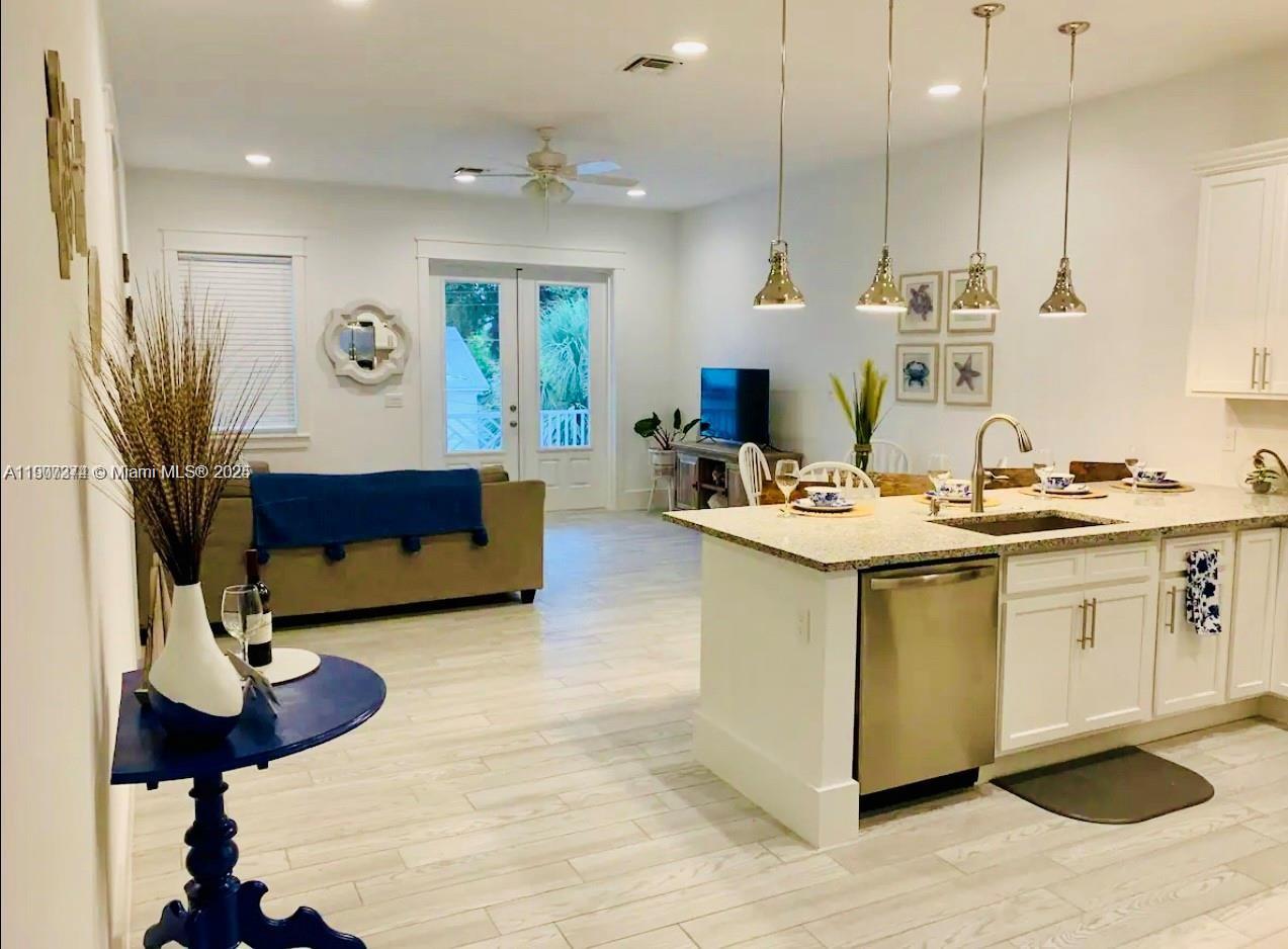 667 Southwest Cleveland Avenue, Unit 3 Stuart, FL 34994 - Photo 10 of 42 a living room with stainless steel appliances kitchen island granite countertop furniture and a view of kitchen