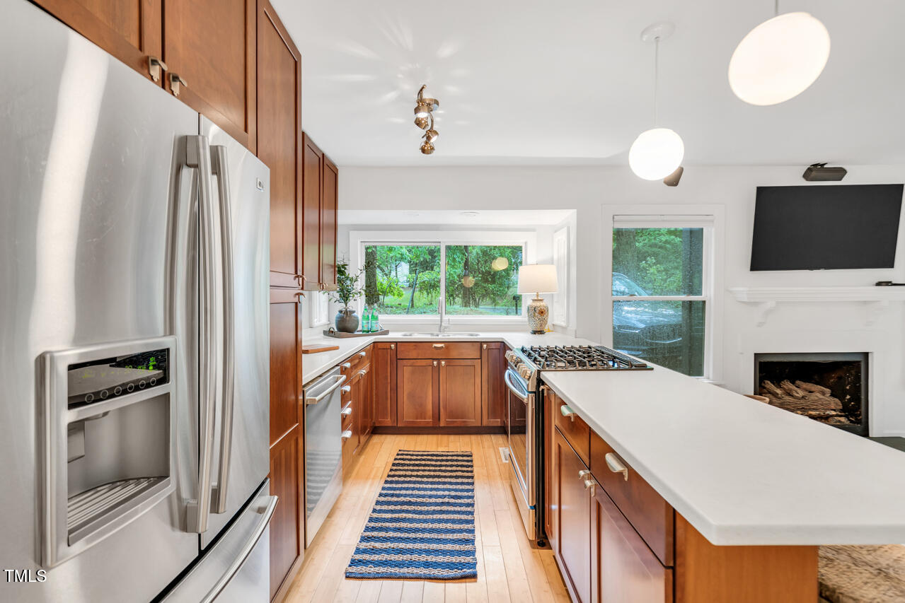 121 Lady Bug Lane Chapel Hill, NC 27516 - Photo 9 of 36 a kitchen with a refrigerator and a stove