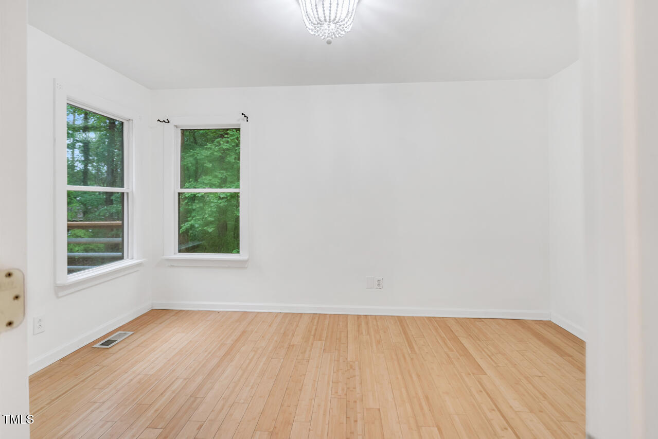 121 Lady Bug Lane Chapel Hill, NC 27516 - Photo 16 of 36 an empty room with wooden floor and windows