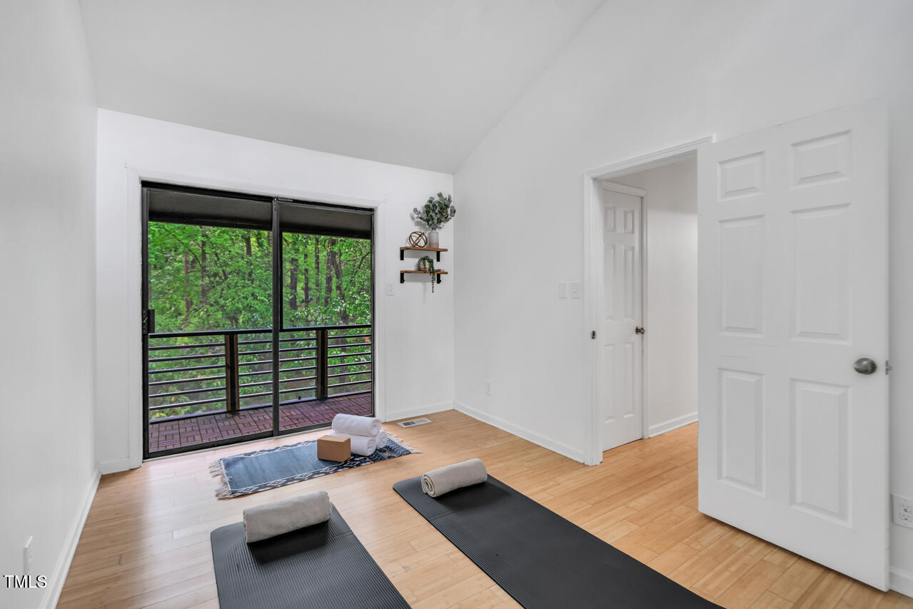121 Lady Bug Lane Chapel Hill, NC 27516 - Photo 20 of 36 a bedroom with furniture and large windows