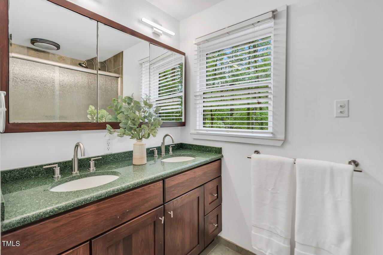 121 Lady Bug Lane Chapel Hill, NC 27516 - Photo 24 of 36 a bathroom with a granite countertop sink and a mirror