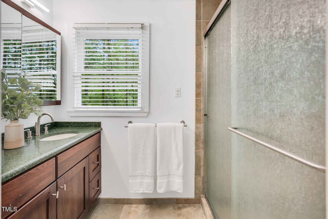 121 Lady Bug Lane Chapel Hill, NC 27516 - Photo 25 of 36 a bathroom with a granite countertop sink and a window