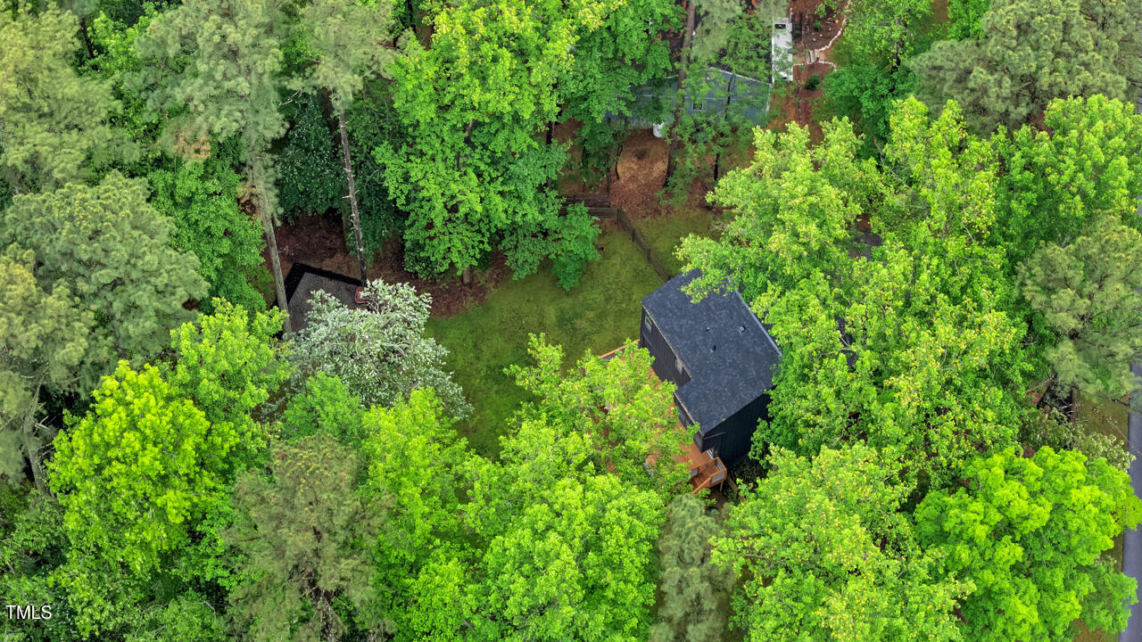 121 Lady Bug Lane Chapel Hill, NC 27516 - Photo 27 of 36 a view of a garden with a bench and trees