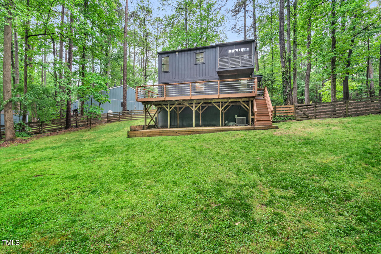 121 Lady Bug Lane Chapel Hill, NC 27516 - Photo 33 of 36 a view of a house with backyard and a tree