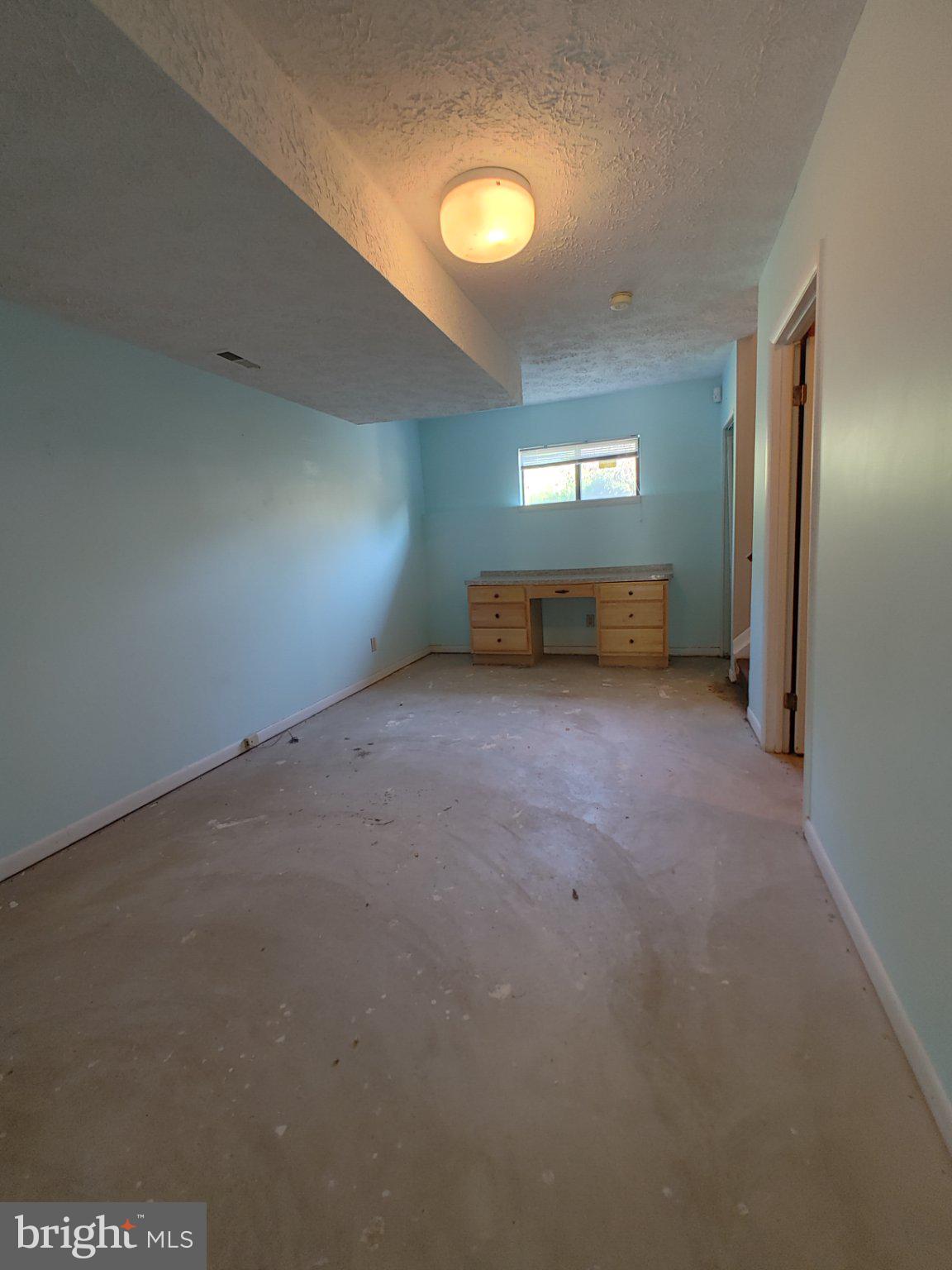 204 Granada Road Pasadena, MD 21122 - Photo 19 of 24 Spacious room with serene blue walls.