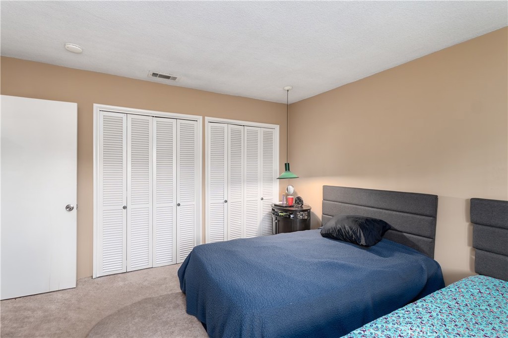 4967 Chapala Drive Riverside, CA 92507 - Photo 24 of 34 a bedroom with a bed and a closet
