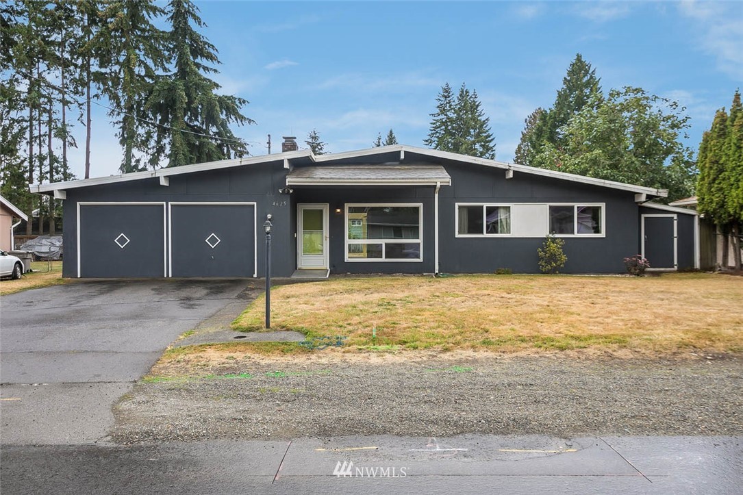4625 Northeast 23rd Street Renton, WA 98059 - Photo 1 of 24 a house with trees in the background