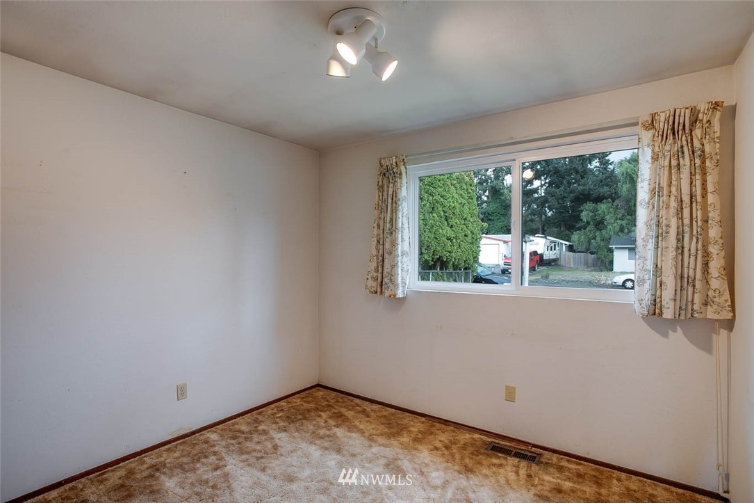 4625 Northeast 23rd Street Renton, WA 98059 - Photo 19 of 24 an empty room with wooden floor and a large window