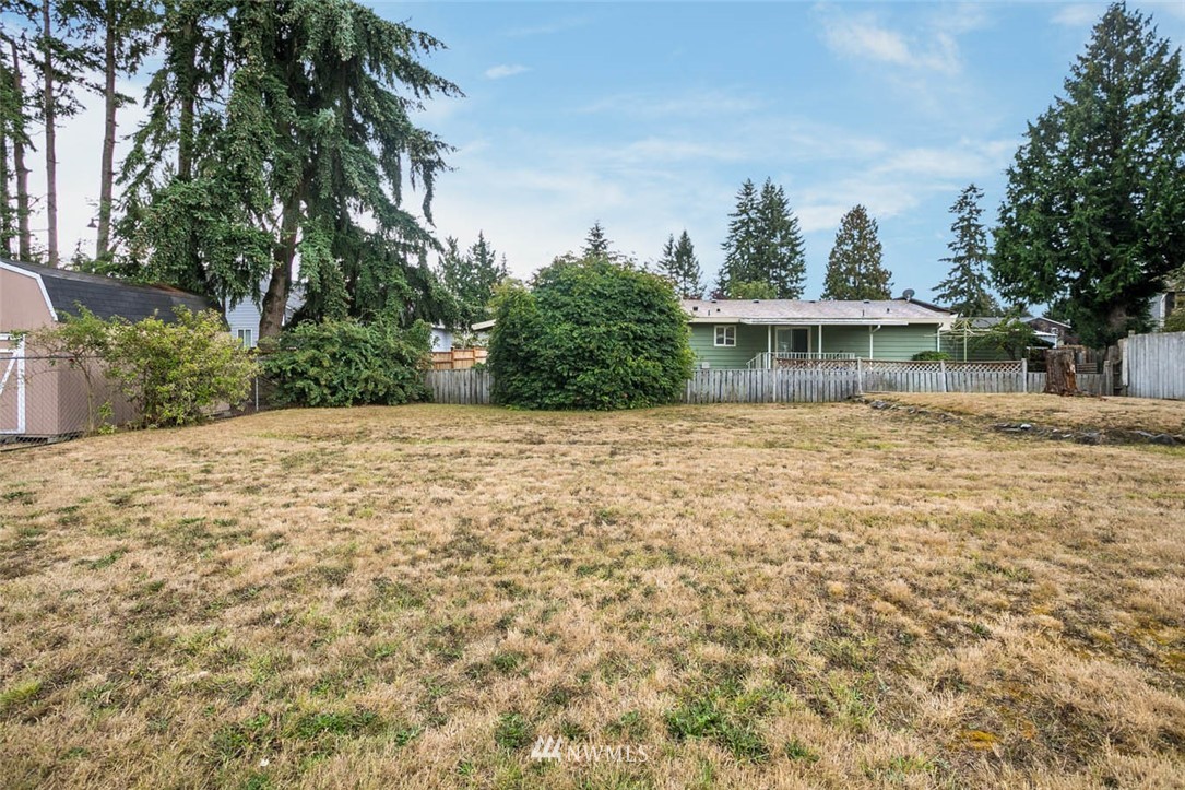 4625 Northeast 23rd Street Renton, WA 98059 - Photo 22 of 24 a front view of a house with a yard and trees