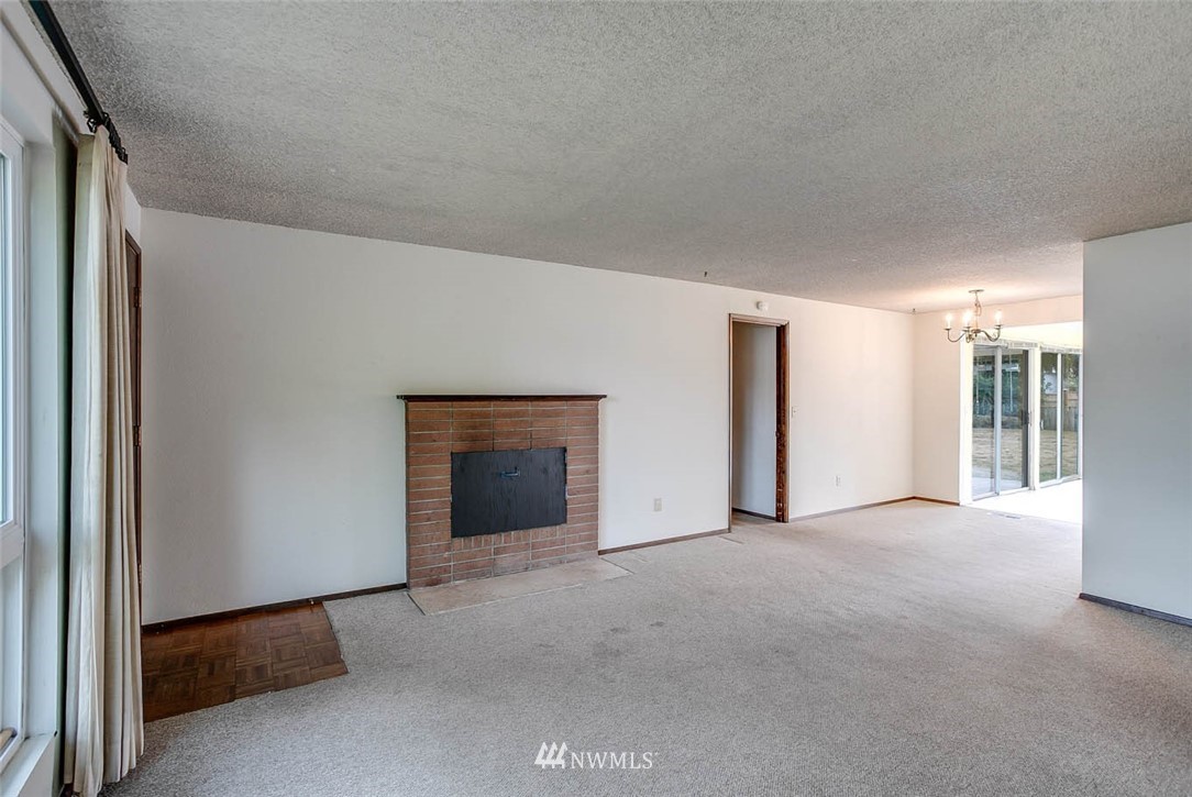4625 Northeast 23rd Street Renton, WA 98059 - Photo 4 of 24 a view of an empty room with a fireplace