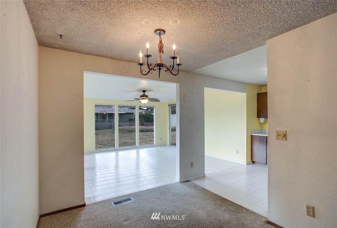 4625 Northeast 23rd Street Renton, WA 98059 - Photo 7 of 24 an empty room with chandelier and glass door
