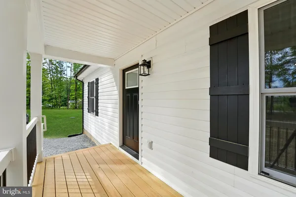 a view of a porch with wooden floor and outdoor space