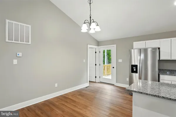 a view of a kitchen with a sink and refrigerator