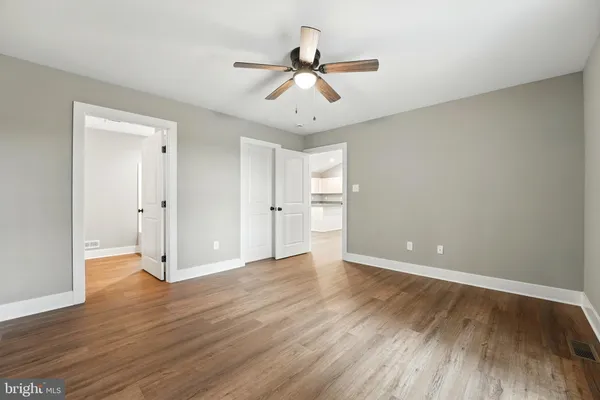 a view of an empty room and wooden floor